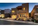 Modern two-story home showcasing contemporary architecture, stone details, desert landscaping, and stylish curb appeal at 221 Errogie St, Henderson, NV 89012