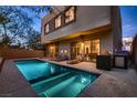 Backyard pool area with lounge chairs and a built-in barbecue, perfect for outdoor relaxation and entertaining at 221 Errogie St, Henderson, NV 89012