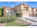 Charming stucco home featuring a three-car garage, fountain, and well-manicured landscaping at 2728 Monrovia Dr, Las Vegas, NV 89117