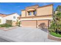 Charming stucco home featuring a three-car garage and well-manicured landscaping at 2728 Monrovia Dr, Las Vegas, NV 89117