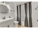 Bathroom featuring an above-counter sink and a shower and tub combination with modern gray and white curtains at 3318 N Decatur Blvd # 2007, Las Vegas, NV 89130