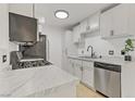 Bright kitchen features stainless steel appliances, light wood flooring and white cabinets with black hardware at 3318 N Decatur Blvd # 2007, Las Vegas, NV 89130
