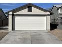 A two car garage with a clean white door and driveway at 4240 Caliper Dr, Las Vegas, NV 89110