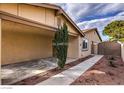 Side view of cozy home with covered parking, small well-maintained landscaping, and gated access to the backyard at 4522 Via San Rafael, Las Vegas, NV 89103