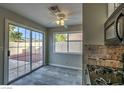 Bright eat-in kitchen featuring tile floors, a window with backyard views, and a sliding door to the patio at 4522 Via San Rafael, Las Vegas, NV 89103