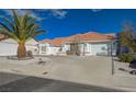 Single-story home featuring a terracotta roof, desert landscaping, and an attached garage at 519 Cayuga Ct, Boulder City, NV 89005