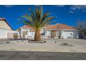 Single-story home featuring a terracotta roof, desert landscaping, and a circular driveway at 519 Cayuga Ct, Boulder City, NV 89005