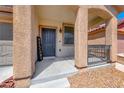 Close up of a well-maintained home exterior with welcoming front door and covered porch at 5507 Nickel Ridge Way, Las Vegas, NV 89122