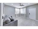 Bright living room with modern gray color scheme, tile flooring, and natural light at 5507 Nickel Ridge Way, Las Vegas, NV 89122