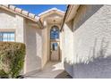 Inviting entryway featuring neutral paint, stylish lighting, and a charming covered walkway at 5732 Colwood Ln, Las Vegas, NV 89130