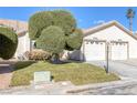 Charming home featuring a well-manicured lawn and a two-car garage, perfect for suburban living at 5732 Colwood Ln, Las Vegas, NV 89130