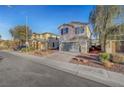 Street view of a two-story home with a two-car garage and low-maintenance landscaping at 5736 Clear Haven Ln, North Las Vegas, NV 89081