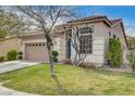 Low angle view of a single-story home showcasing the well-kept lawn and traditional architecture under a sunny, blue sky at 5965 Poplar Tree St, Las Vegas, NV 89148