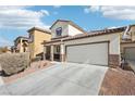 Lovely home with a two-car garage, desert landscaping, and a welcoming entrance at 6116 Casa Antiqua St, North Las Vegas, NV 89081