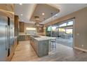 Gourmet kitchen featuring an island, stainless steel appliances, and easy outdoor access at 6832 Apogee Ridge Ct, Las Vegas, NV 89135