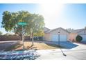 Charming single-story home featuring a well-maintained lawn and a two-car garage at 7485 Rainbow Spray Dr, Las Vegas, NV 89131