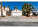 Single-story home with a two-car garage and desert landscaping in a sunny neighborhood at 7608 Little Valley Ave, Las Vegas, NV 89147