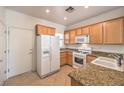 Functional kitchen with stainless appliances, granite countertops and light wood cabinets at 7928 Broadwing Dr, North Las Vegas, NV 89084