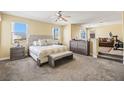 Spacious main bedroom featuring a king-size bed, a seating area and an ensuite bath at 8106 Buffalo Clan Ct, Las Vegas, NV 89131