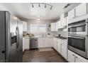 Updated kitchen with stainless steel appliances, white cabinets, and modern lighting at 8212 Ducharme Ave, Las Vegas, NV 89145