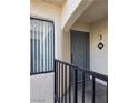 A condo entrance with a gray door and a dark metal railing at 8455 W Sahara Ave # 258, Las Vegas, NV 89117