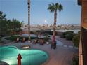 Inviting backyard pool and spa area with lounge chairs, a trampoline, and desert landscaping at 9012 Alpine Peaks Ave, Las Vegas, NV 89147