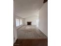 Spacious living room with carpet flooring and a brick fireplace at 904 Dianne Dr, Boulder City, NV 89005