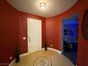 Inviting entryway with decorative tile flooring, a white front door, and arched doorway at 9364 Olympia Falls Ave, Las Vegas, NV 89149