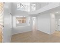 Bright living room with soaring ceilings, tile floors, fresh paint, and clerestory windows at 10651 Streamside Ave, Las Vegas, NV 89129