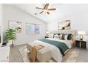 Comfortable main bedroom features a ceiling fan, neutral decor, and lots of natural light at 10651 Streamside Ave, Las Vegas, NV 89129