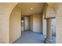 Inviting front porch features an arched entrance and stone column, offering a warm welcome at 11165 Robin Park Ave, Las Vegas, NV 89138