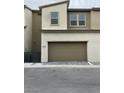 Exterior showing large garage door of a new construction home with paver driveway at 11394 Ethereal Landing Ave, Las Vegas, NV 89138