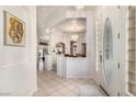 Elegant foyer with tile flooring, decorative glass door, and views of the dining room at 2329 Quartz Peak St, Las Vegas, NV 89134