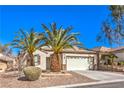 Charming single-story home featuring a two-car garage, desert landscaping, and mature palm trees in front at 2554 Corvus St, Henderson, NV 89044