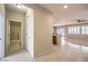 Bright, open living area with tile floors, a ceiling fan, and large windows that let in plenty of natural light at 2554 Corvus St, Henderson, NV 89044