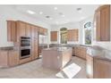 Spacious kitchen with custom wood cabinets, granite countertops, stainless steel appliances and kitchen island at 379 Turquoise Ct, Boulder City, NV 89005