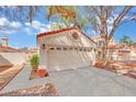 Inviting home exterior with an attached two-car garage and neatly kept landscaping at 3916 Rhine Way, Las Vegas, NV 89108