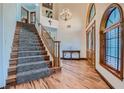 Grand foyer with hardwood floors, high ceilings, staircase, and a chandelier at 4075 E Oquendo Rd, Las Vegas, NV 89120