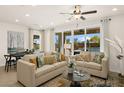 Bright living room featuring neutral furniture, large windows, and an open concept layout with dining area at 4220 E Brusca Way, Pahrump, NV 89061