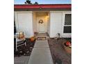 Charming front porch with decorative seasonal elements creates a warm and inviting entrance to the home at 470 Como Ct, Henderson, NV 89015