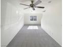 Clean, empty living room featuring neutral carpet, ample natural light, and fresh paint at 5212 Paradise Skies Ave, Las Vegas, NV 89156