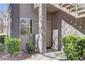 Exterior shot of unit entrance with a security door and desert landscaping at 5250 S Rainbow Blvd # 1121, Las Vegas, NV 89118