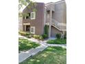 Two story apartment building with staircase, grass and landscaping at 5250 S Rainbow Blvd # 1121, Las Vegas, NV 89118