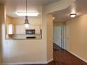 Open-concept living room features wood floors leading to the kitchen and hallways at 5250 S Rainbow Blvd # 1121, Las Vegas, NV 89118