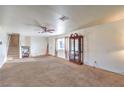 Spacious living room showcasing carpet flooring, ceiling fan, and staircase at 6240 Clarice Ave, Las Vegas, NV 89107