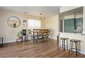 Dining area with modern table and chairs, adjacent to updated kitchen at 6424 Old Colonial Way, Las Vegas, NV 89108