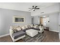 Comfortable living room with a large sectional sofa, ceiling fan, and wood-look floors at 6717 Atwood Ave, Las Vegas, NV 89108