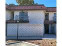 Exterior shot of a two-story townhome with balcony and red tile roof at 701 Bourbon St # G3, Pahrump, NV 89048