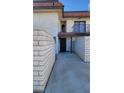 Townhome exterior with brick accents and a manicured pathway at 701 Bourbon St # G3, Pahrump, NV 89048