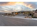 A single story home featuring desert landscaping, three car garage, and a paver driveway at 733 Aberdeen Tartan St, Las Vegas, NV 89138